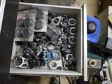 a metal box filled with assorted metal parts