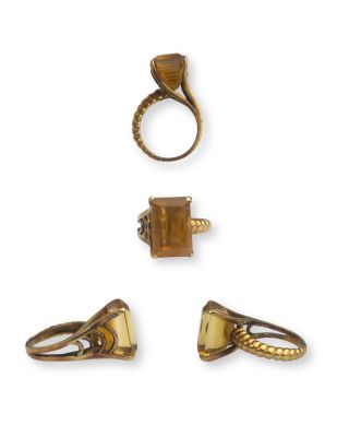 three gold rings and a ring with a square shaped stone