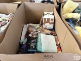 a cardboard box filled with books and other items