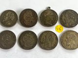 six different types of coins are shown on a white surface