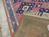 a cat that is sitting on a rug on the floor