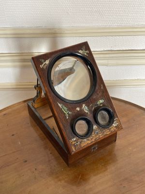 a small wooden table with a mirror on top of it