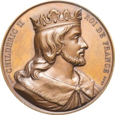 une image représentant une médaille d'or sur laquelle figure un homme coiffé d'une couronne