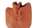 a clay sculpture of a cow on a white background