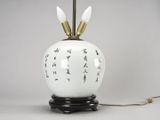 an image of a white lamp with black and gold decorations on it