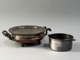 an image of a silver plate and a silver cup on a white surface