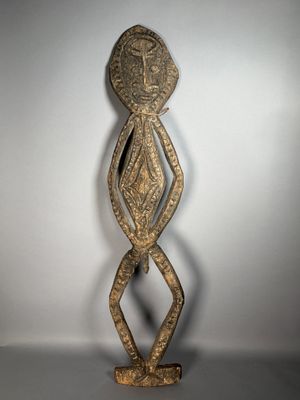 a wooden sculpture of a woman with a face and arms