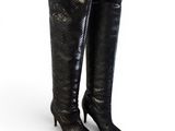 a pair of black snakeskin boots on a white background