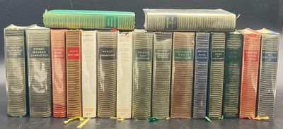 many books stacked on top of each other on a table