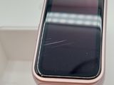 a pink apple watch sitting on top of a white table