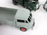 a green toy truck and a green toy truck