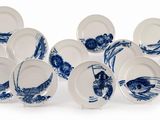 a lot of blue and white plates on a white surface