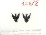 pair of black eagle stud earrings on white paper with red writing
