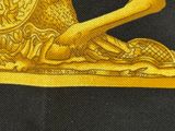 a close up of a gold snail on a black background