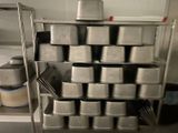 many pans on the shelf in the kitchen