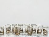 six glasses that are sitting on a marble table
