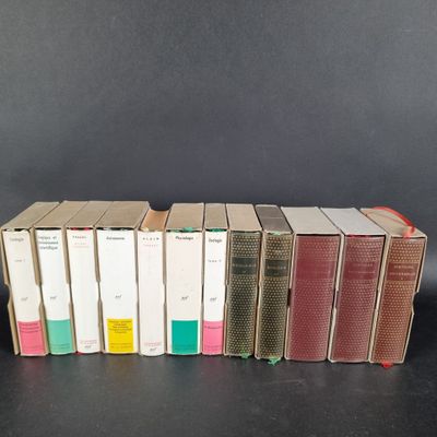 several books are stacked on top of each other on a table