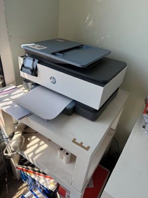 a printer that is sitting on top of a stack of boxes