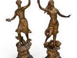 pair of antique bronze figurines of a woman and a man