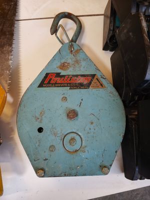 some tools are sitting on a shelf next to a pair of scissors