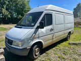 an image of a silver van parked in a field