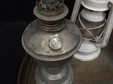 a metal lamp that is sitting next to a lantern