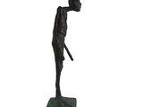statue of a man holding a baseball bat on top of a green base