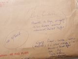 a brown envelope with writing on it sitting on a table