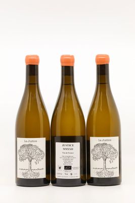 three bottles of wine sitting next to each other on a white surface