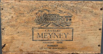 an old wooden box with a label on it sitting on a table