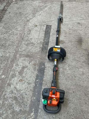 an image of a string trimmer laying on the ground