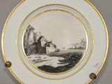 two plates with a picture of a boat on them on a table