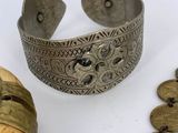 an image of a silver bracelet and a wooden object on a table