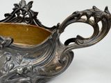 a silver bowl that is sitting on a table