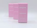three pink boxes of perfume sitting on top of a white surface
