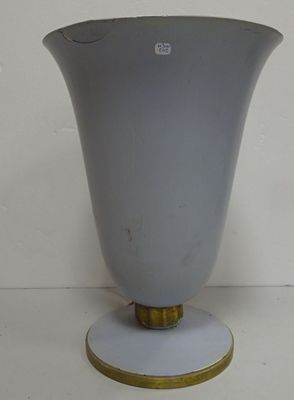 a white vase with a gold rim sitting on a table