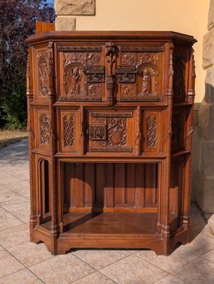 a wooden cabinet that has carvings on the front of it