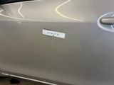 a sticker on the door of a silver car