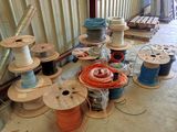many spools of different colors and sizes on the floor