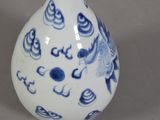 a blue and white vase with a fish design on it