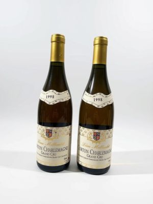 deux bouteilles de vin posées l'une à côté de l'autre sur une surface blanche