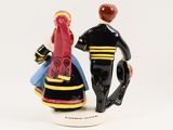 a figurine of a man and a woman holding hands