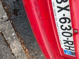 a red car parked on the side of the road