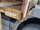 a truck that has a hose in the back of it