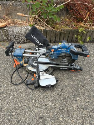 a blue and black circular saw sitting on the ground