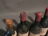 several bottles of wine are lined up on a shelf