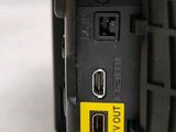 a black camera with a yellow sticker on it
