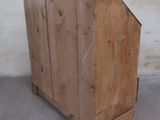 a wooden cabinet that is sitting on the ground
