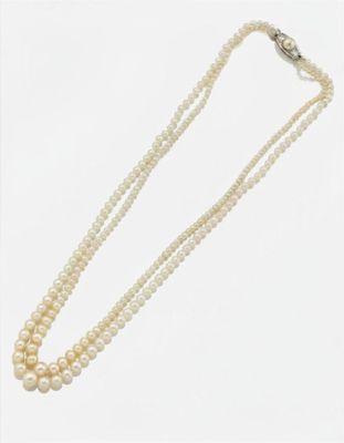 gros plan d'un collier de perles sur fond blanc