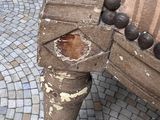 an old wooden bench with peeling paint on it ' s legs